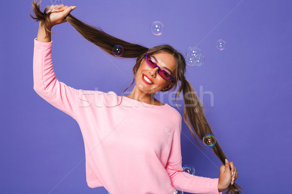 Portrait of teenage woman in sweatshirt wearing trendy sunglasse Stock photo © deandrobot