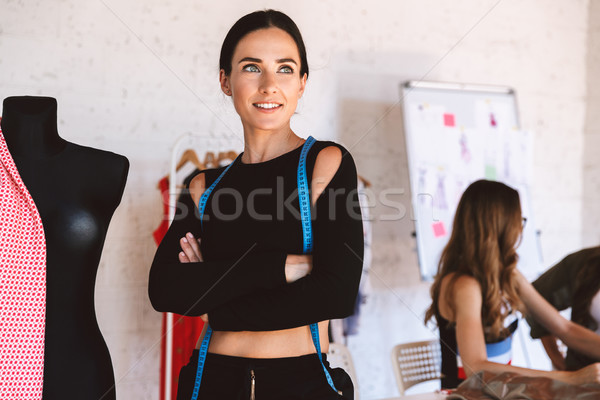 Smiling young woman clothes designer at the atelier Stock photo © deandrobot