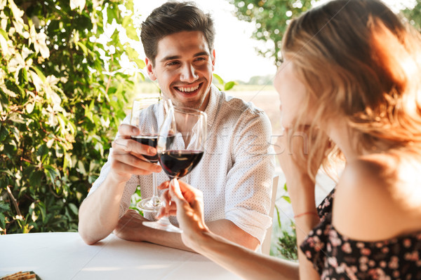 Loving couple sitting in cafe by dating drinking wine Stock photo © deandrobot