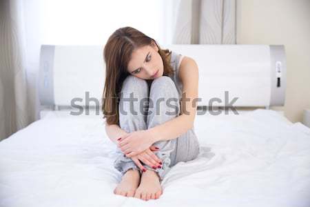 Fiatal nő ül ágy fájdalom gyomor nő Stock fotó © deandrobot
