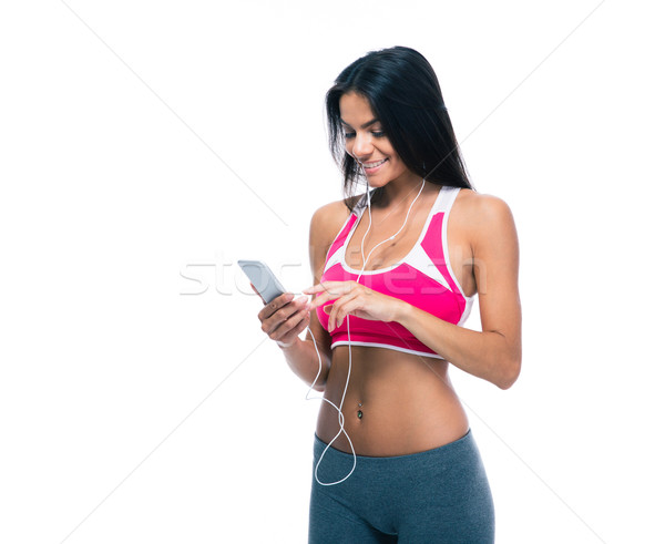 Smiling woman listening music in headphones Stock photo © deandrobot