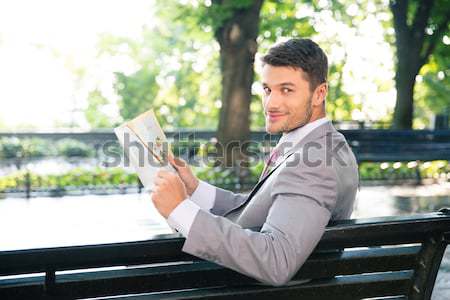 Portrait of a pensive businessman sitting on the bench Stock photo © deandrobot