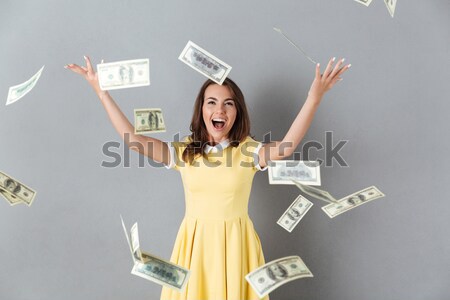 Afro american woman standing under rain with money Stock photo © deandrobot