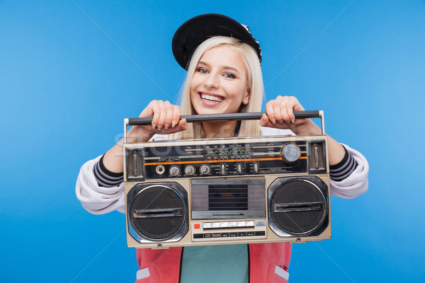 Smiling woman holding boom box  Stock photo © deandrobot