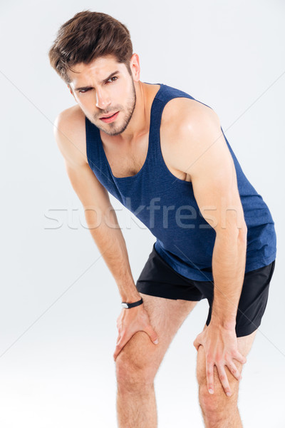 Tired handsome young man athlete standing and resting Stock photo © deandrobot