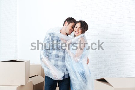 Young beautiful couple unpacking in new flat Stock photo © deandrobot