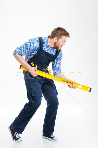 Full length portrait of a funny male builder Stock photo © deandrobot