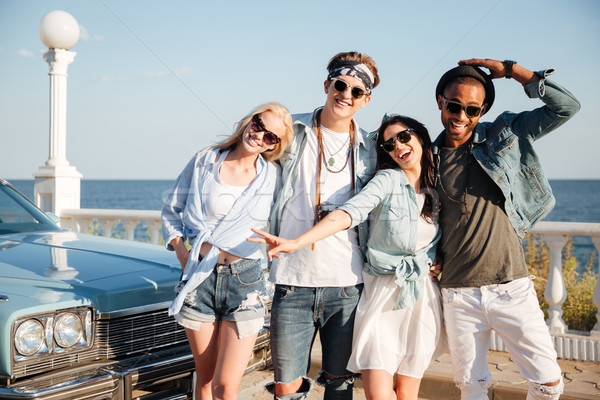 Group of happy young people standing on promenade Stock photo © deandrobot
