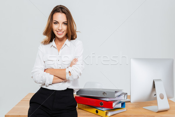 Businesswoman with hands folded standing at the office Stock photo © deandrobot