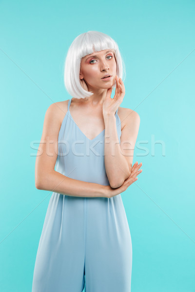 Stock photo: Stylish pretty young woman in blonde wig standing