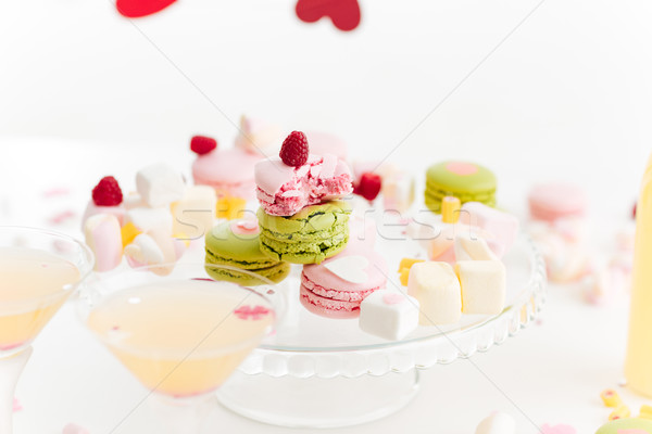Broken french macaroons, marshmallows and cocktails on the table Stock photo © deandrobot