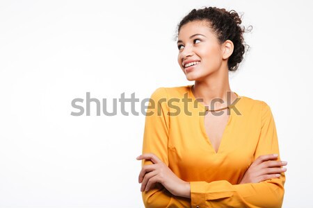 Gorgeous young curly african lady looking aside. Stock photo © deandrobot