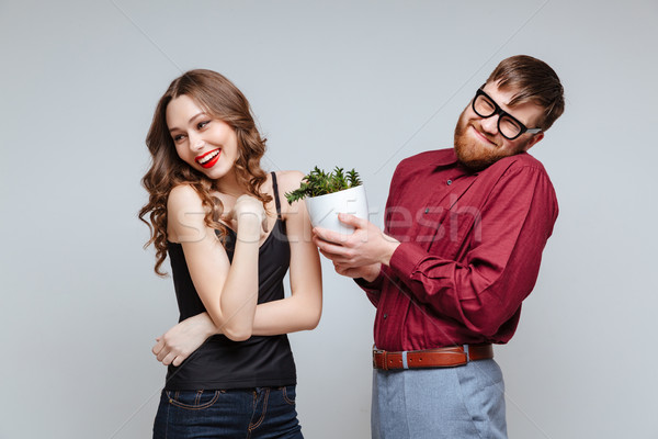 Shy Male nerd presents the plant for Shy girl Stock photo © deandrobot