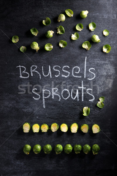 Image of brussels sprouts over dark background. Stock photo © deandrobot