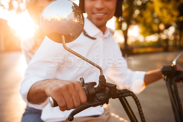 Cropped image of happy african couple rides on modern motorbike Stock photo © deandrobot