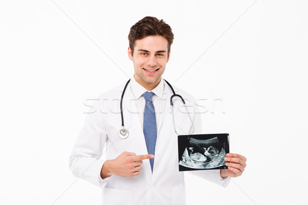 Portret uśmiechnięty młodych mężczyzna lekarz stetoskop uniform Zdjęcia stock © deandrobot