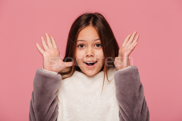 Menina feliz olhando câmera as mãos levantadas isolado feliz Foto stock © deandrobot