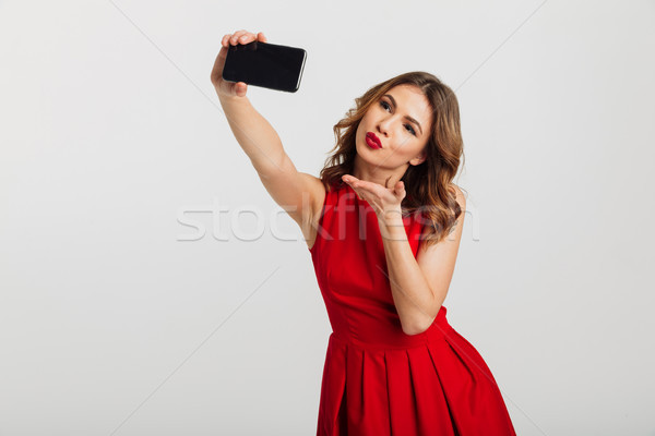 Portrait jeune femme robe rouge air [[stock_photo]] © deandrobot
