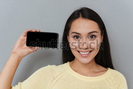 Alegre mulher lábios vermelhos exibir telefone móvel Foto stock © deandrobot