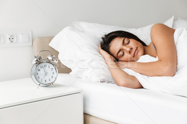 Portrait of beautiful young woman sleeping in bed at bedroom, wi Stock photo © deandrobot