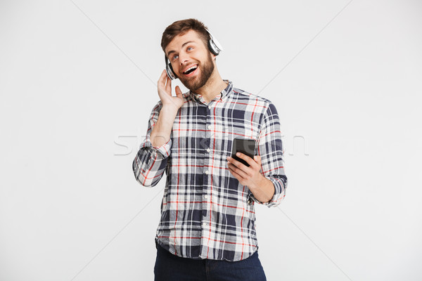 Portrait of a smiling young man in plaid shirt Stock photo © deandrobot