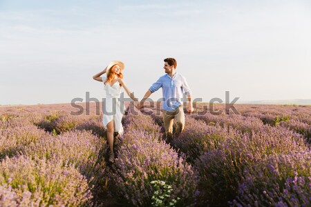 Cheery young couple embracing at the lavender field Stock photo © deandrobot
