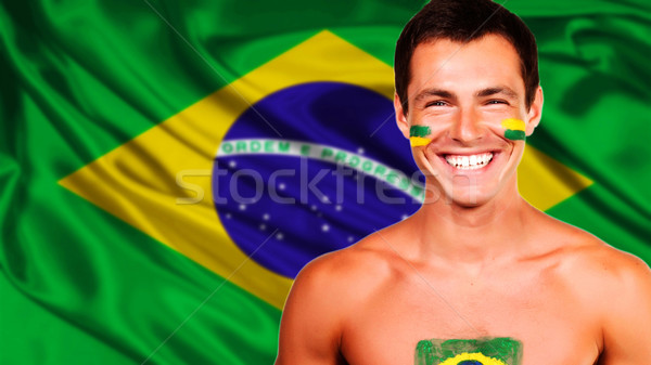 Happy brazilian fan celebrating over brazil flag background Stock photo © deandrobot