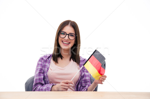 Young woman sitting at the table with German flag Stock photo © deandrobot