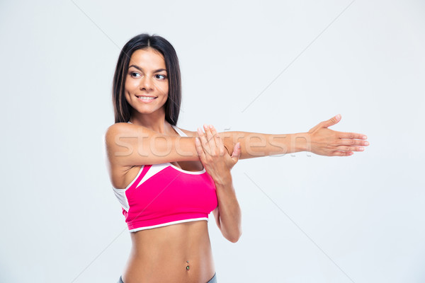 Happy sports woman stretching hands Stock photo © deandrobot