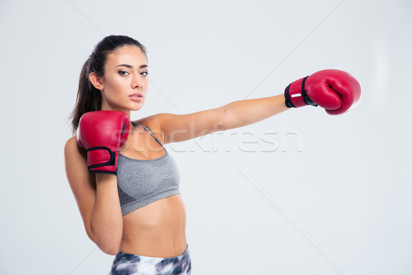 Portrait of a beautiful fitness woman in boxing glove Stock photo © deandrobot