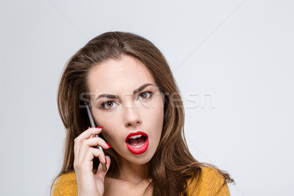 Nő nyitott szájjal beszél telefon portré meglepett Stock fotó © deandrobot