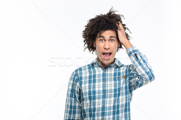 Zdziwiony afro amerykański człowiek kręcone włosy patrząc Zdjęcia stock © deandrobot