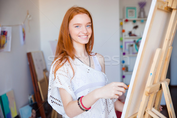 Lovely cute joyful woman artist enjoying drawing in art workshop Stock photo © deandrobot