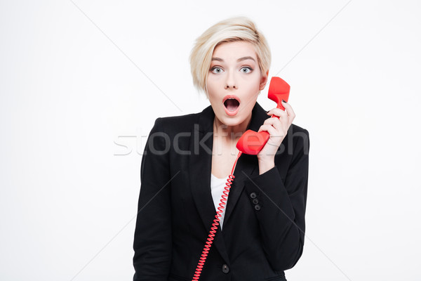 Meglepett üzletasszony tart telefon cső izolált Stock fotó © deandrobot
