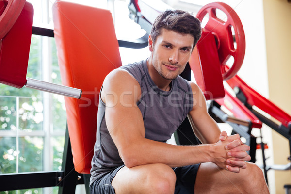Portrait of a fitness man resting on bench at gym Stock photo © deandrobot