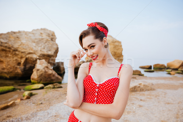 Young beautiful pin up girl in red swimsuit posing Stock photo © deandrobot