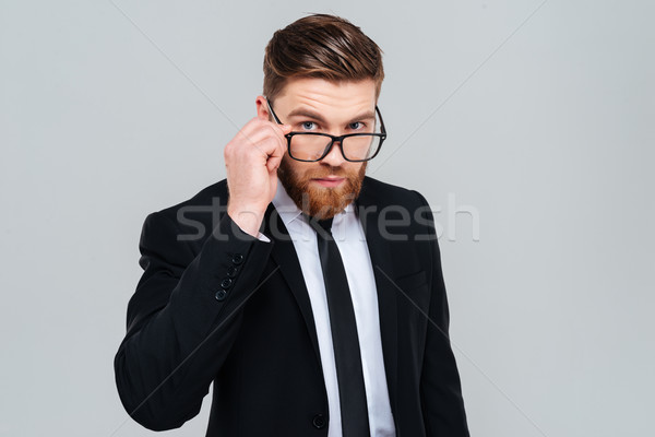 Foto stock: Homem · de · negócios · olhando · óculos · bonito · terno · preto · isolado