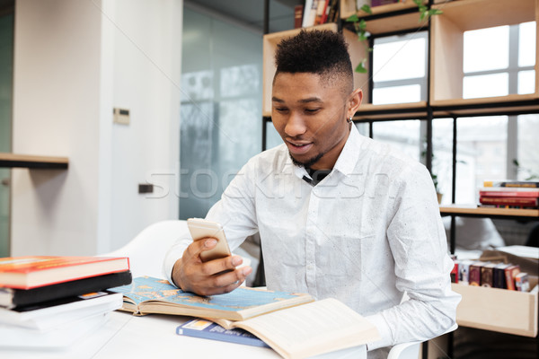 Fiatal afrikai diák könyvtár beszélget telefon Stock fotó © deandrobot