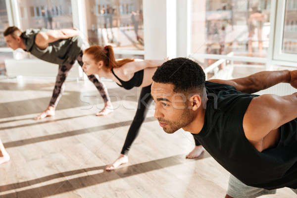 Concentré africaine homme yoga groupe studio [[stock_photo]] © deandrobot