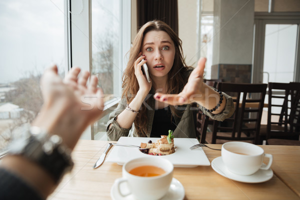 Dissatisfied woman in cafe Stock photo © deandrobot