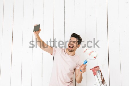 Young man winner showing fan finger isoloated Stock photo © deandrobot