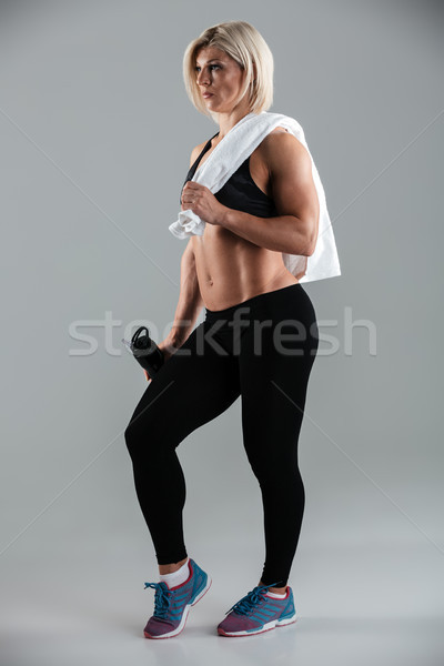 Full length portrait of a fit muscular adult sportswoman Stock photo © deandrobot