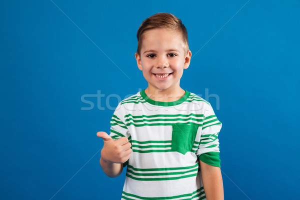Portrait of a happy kid showing thumbs up gesture Stock photo © deandrobot