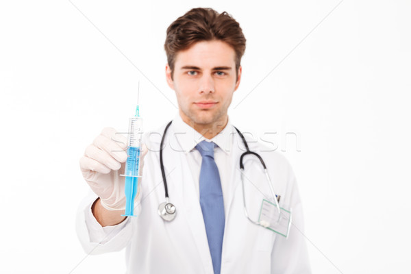 Close up portrait of a confident young male doctor Stock photo © deandrobot