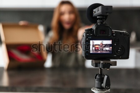 Smiling young girl recording video blog episode Stock photo © deandrobot