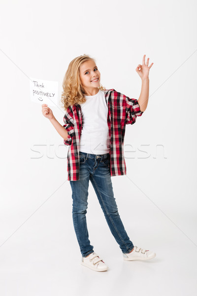 Full length portrait of a smiling little girl Stock photo © deandrobot