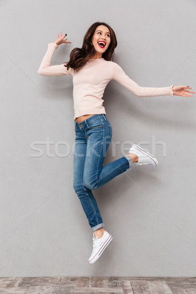 Full-length shot of caucasian smiling woman with red lips makeup Stock photo © deandrobot