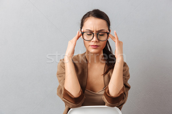 Portrait of a concentrated young asian woman Stock photo © deandrobot