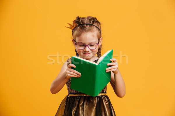 Pretty girl child wearing princess crown reading book. Stock photo © deandrobot