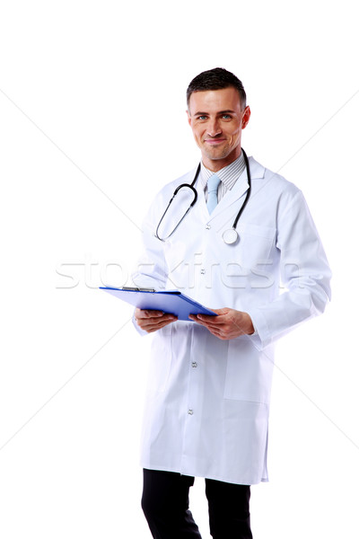 Smiling male Doctor standing with clipboard over white background Stock photo © deandrobot